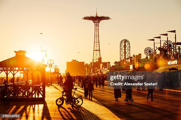 coney island boardwalk at sunset - coney island stock-fotos und bilder