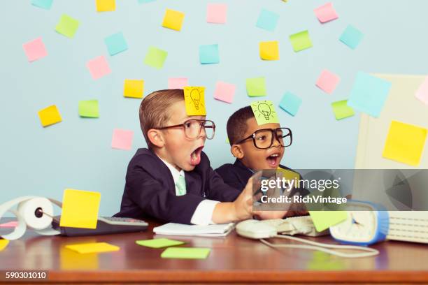 two young businessmen covered with light bulb sticky notes - stressed funny stock pictures, royalty-free photos & images