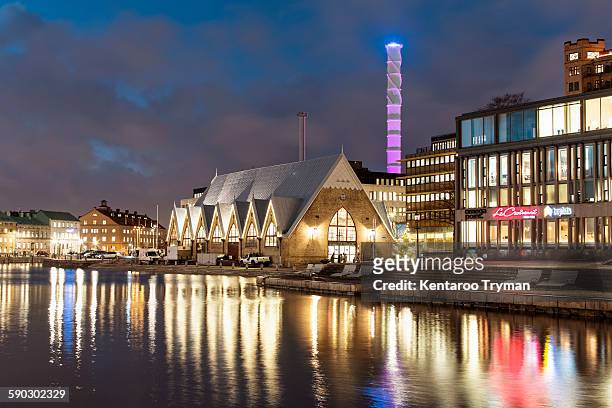 illuminated buildings in city by river at night - göteborg bildbanksfoton och bilder