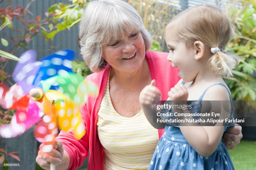 Grandmother and granddaughter with pinwheel