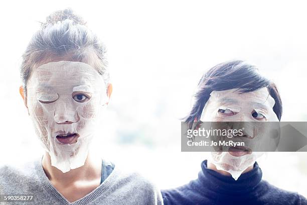 two women with tissue covering face - handkerchief - fotografias e filmes do acervo