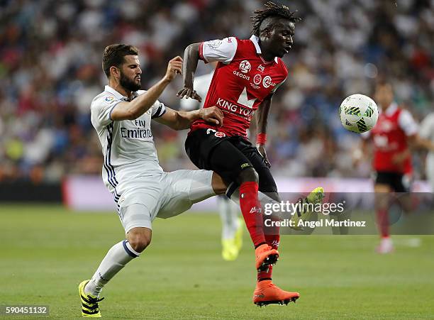 Nacho Fernandez of Real Madrid competes for the ball with Ibrahima Balde of Stade de Reims during the Trofeo Santiago Bernabeu match between Real...