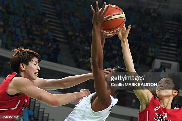 Japan's power forward Ramu Tokashiki defends against USA's small forward Angel Mccoughtry during a Women's quarterfinal basketball match between USA...