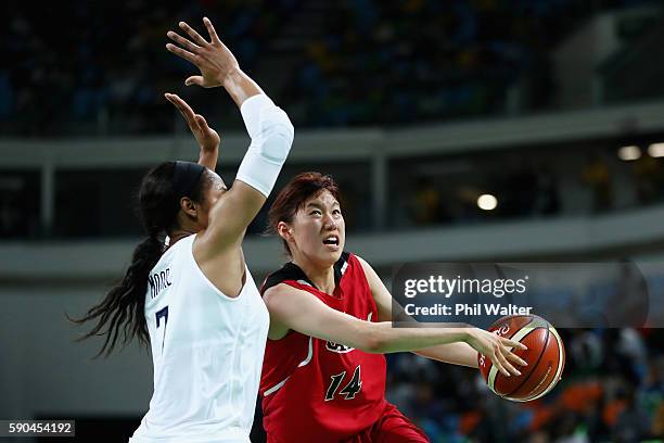 Sanae Motokawa of Japan drives against Maya Moore of United States during the Women's Quarterfinal match on Day 11 of the Rio 2016 Olympic Games at...