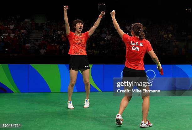 Ning Ding and Shiwen Liu of China celebrate winning gold in the their doubles match against Petrissa Solja and Xiaona Shan of Germany in the Women's...