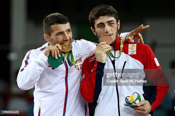 Gold medalist Davor Stefanek of Serbia and bronze medalists Shmagi Bolkvadze of Georgia celebrate during the medal ceremony after the Men's...