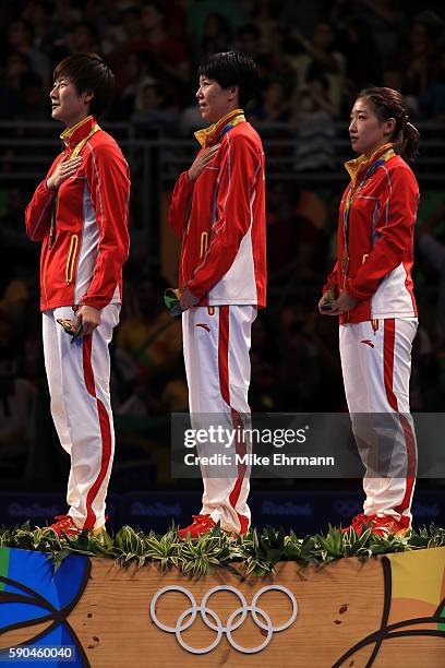 Gold medalists Ning Ding, Xiaoxia Li and Shiwen Liu of China pose on the podium during the medal ceremony for the Women's Team Match between China...