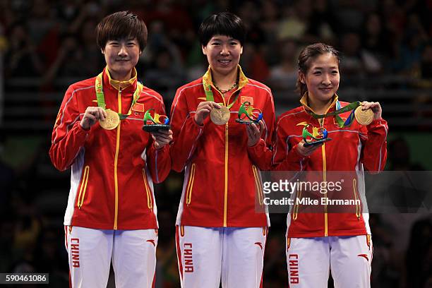 Gold medalists Ning Ding, Xiaoxia Li and Shiwen Liu of China pose on the podium during the medal ceremony for the Women's Team Match between China...