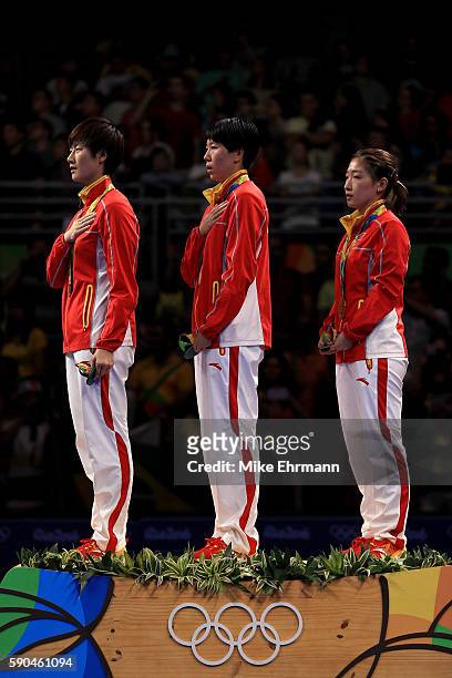Gold medalists Ning Ding, Xiaoxia Li and Shiwen Liu of China pose on the podium during the medal ceremony for the Women's Team Match between China...
