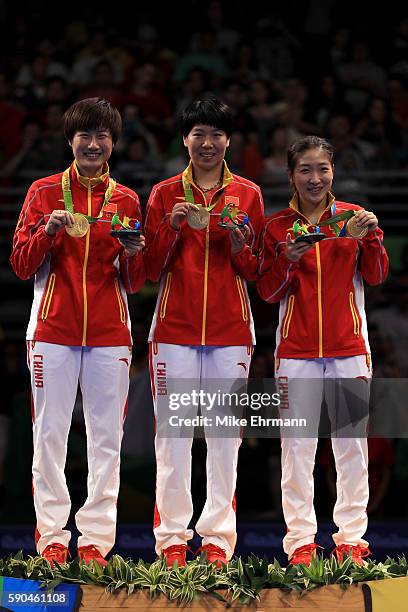 Gold medalists Ning Ding, Xiaoxia Li and Shiwen Liu of China pose on the podium during the medal ceremony for the Women's Team Match between China...