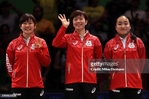 Bronze medalists Mima Ito, Kasumi Ishikawa and Ai Fukuhara of Japan pose on the podium during the medal ceremony for the Women's Team Match between...