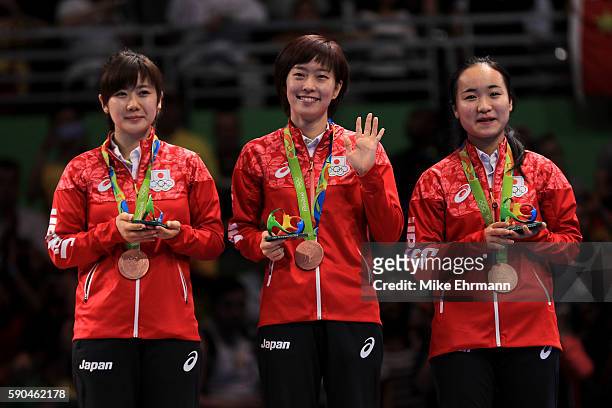 Bronze medalists Mima Ito, Kasumi Ishikawa and Ai Fukuhara of Japan pose on the podium during the medal ceremony for the Women's Team Match between...