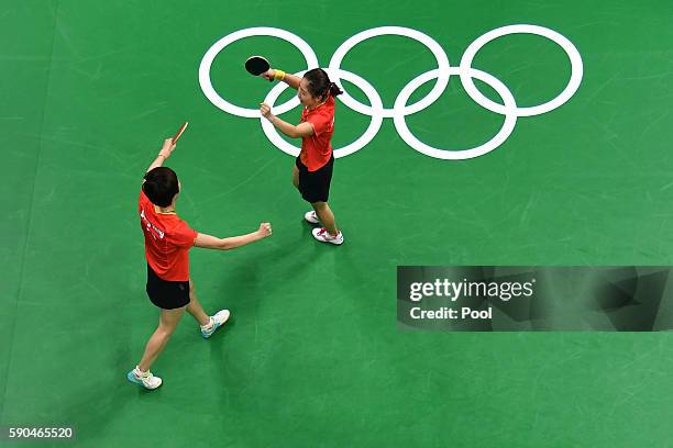 Ning Ding and Shiwen Liu of China celebrate winning gold in the their doubles match against Petrissa Solja and Xiaona Shan of Germany in the Women's...