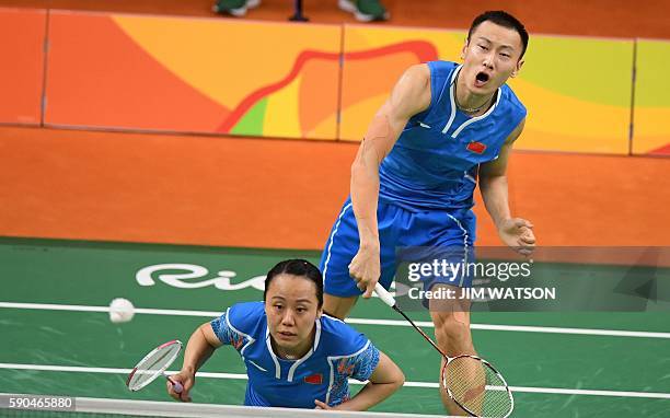 China's Zhang Nan and China's Zhao Yunlei return against China's Xu Chen and China's Ma Jin during their mixed doubles Bronze Medal badminton match...