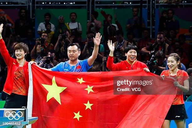 Ding Ning, coach Kong Linghui, Li Xiaoxia and Liu Shiwen of China celebrate after winning the Women's Team Gold Medal Team Match between China and...