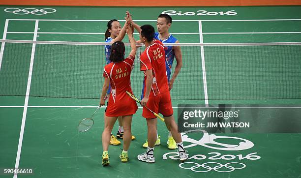 China's Zhang Nan and China's Zhao Yunlei react after winning against China's Xu Chen and China's Ma Jin during their mixed doubles Bronze Medal...
