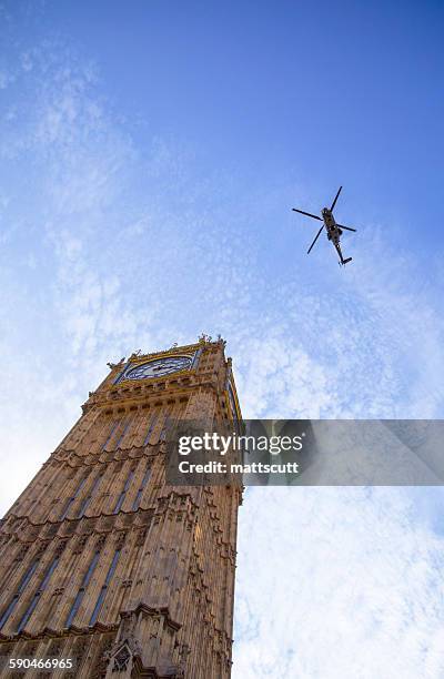 low angle view of a helicopter flying over big ben, london, england, uk - mattscutt imagens e fotografias de stock