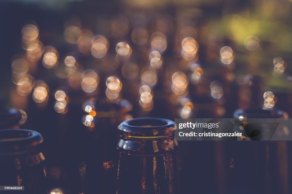 Abstract shot of Rows of beer bottles with bokeh