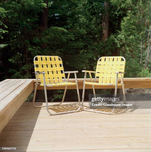 two yellow folding chairs - silla de jardín fotografías e imágenes de stock