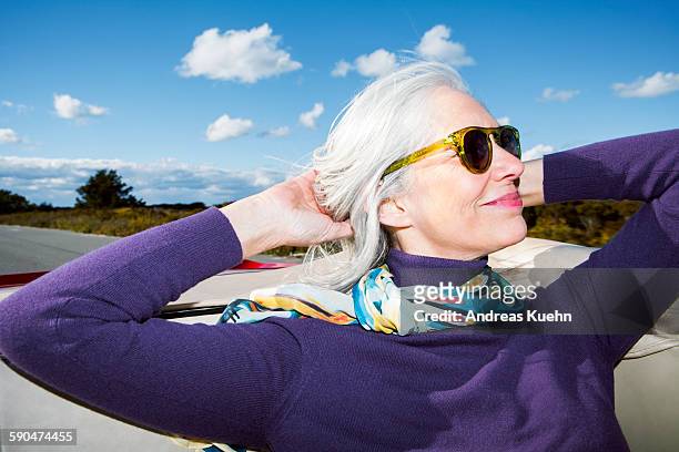 woman enjoying her ride in a convertible. - canas fotografías e imágenes de stock