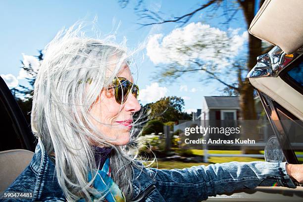 stylish woman driving a convertible. - sunny side stock pictures, royalty-free photos & images