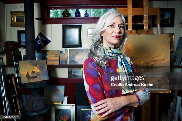 portrait of a woman in her artist studio. - baby boomer stock pictures, royalty-free photos & images