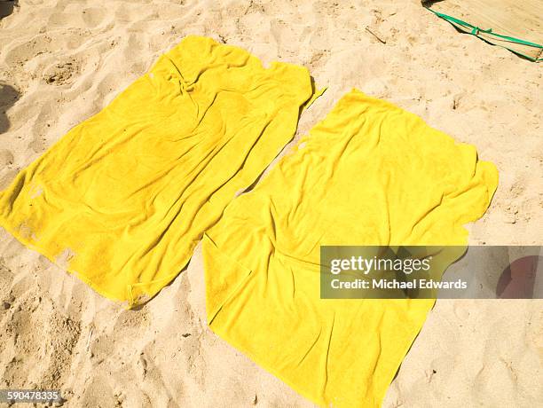 two towels on the beach - towel stock-fotos und bilder
