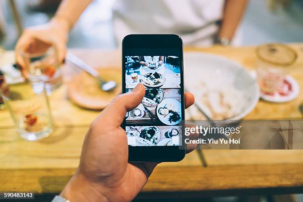 capturing the meal with smartphone in cafe - focus on foreground food stock pictures, royalty-free photos & images