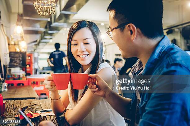 friends toasting each other with coffee in cafe - yiu yu hoi stock pictures, royalty-free photos & images