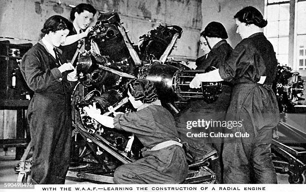 Women 's Auxiliary Air Force - Female mechanics in training. A group of women in overalls study the construction of a radial dial engine.