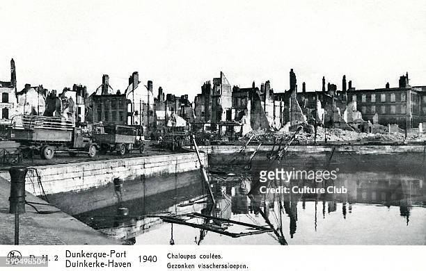 Dunkirk 1940 - view of ruined buildings and partially sunken ship.