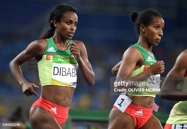 Ethiopia's Genzebe Dibaba and Ethiopia's Dawit Seyaum compete in the Women's 1500m Final during the athletics event at the Rio 2016 Olympic Games at...