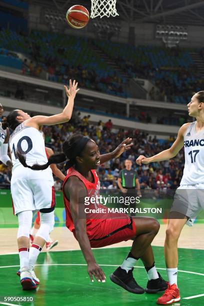 Canada's forward Tamara Tatham falls during a Women's quarterfinal basketball match between France and Canada at the Carioca Arena 1 in Rio de...