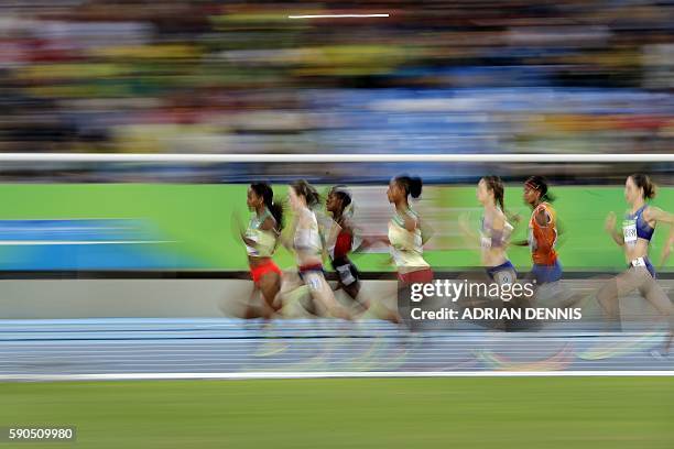 Ethiopia's Genzebe Dibaba, Britain's Laura Muir and Kenya's Faith Chepngetich Kipyegon compete in the Women's 1500m Final during the athletics event...