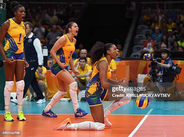 Brazil's Fabiana Claudino, Brazil's Danielle Lins and Brazil's Fernanda Rodrigues celebrate a point during the women's quarter-final volleyball match...