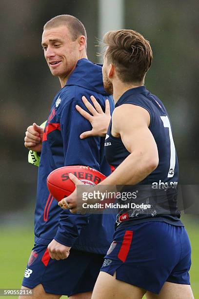 Assistant coach Simon Goodwin, who will be head coach next season, is pushed by Jack Viney during a Melbourne Demons AFL training session at AAMI...