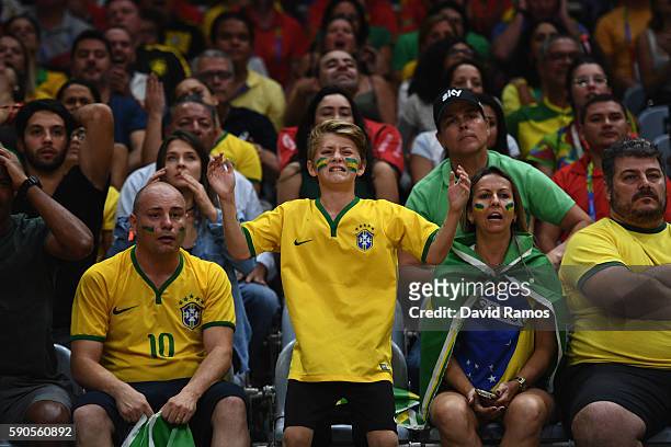 Young fan of Brazil reacts dejected during the Women's Quarterfinal match between China and Brazil on day 11 of the Rio 2106 Olympic Games at the...