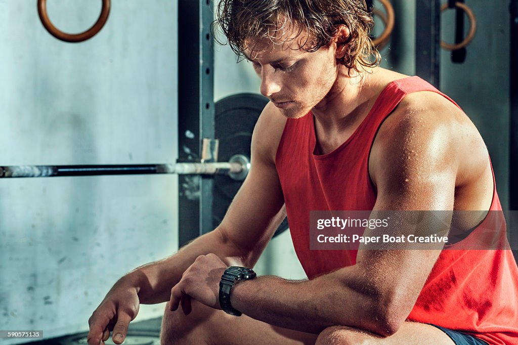 Athlete taking a break from workout, checking time