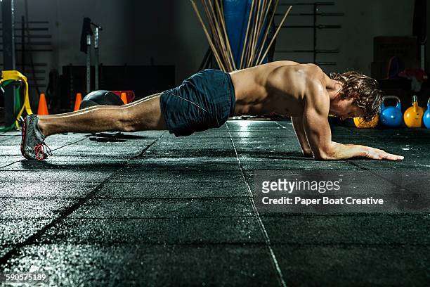 athletic man doing the plank for abs and core - six pack stock pictures, royalty-free photos & images