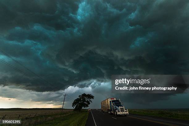 big truck drives under a thunderstorm. texas, usa - tornado sky stock pictures, royalty-free photos & images