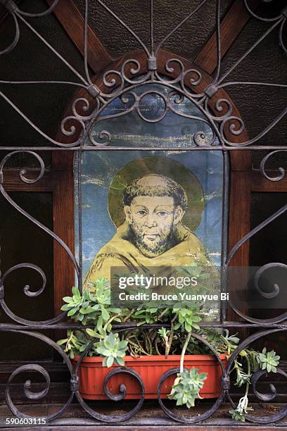 portrait of franciscan monk on a house window - st francis stock pictures, royalty-free photos & images