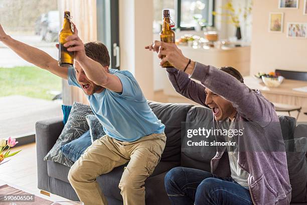 friends watching tv - beer bottle mouth stock pictures, royalty-free photos & images