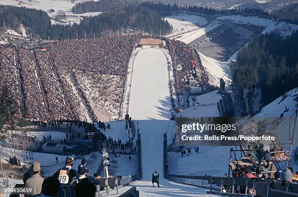 View of a skier competing in the Large hill event of the ski jumping competition at the 1968 Winter Olympic Games at Saint-Nizier-du-Moucherotte near...