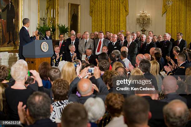 President Barack Obama and the audience applaud members of Specialist Leslie H. Sabo, Jr's., US Army unit as they stand and are acknowledged during a...