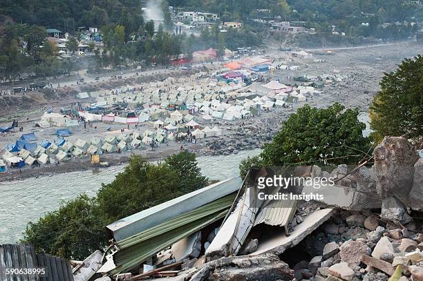 Destroyed Building And Tents In A Relief Camp After The 8 October 2005 Earthquake, Muzaffarabad, Azad Kashmir, Pakistan.