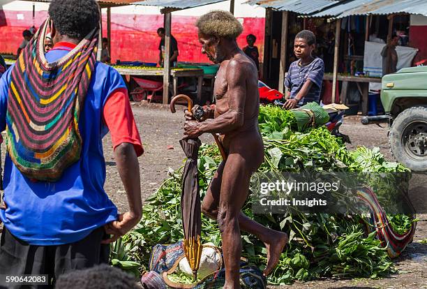 Dani man wearing a koteka at the market, Wamena, Papua, Indonesia.