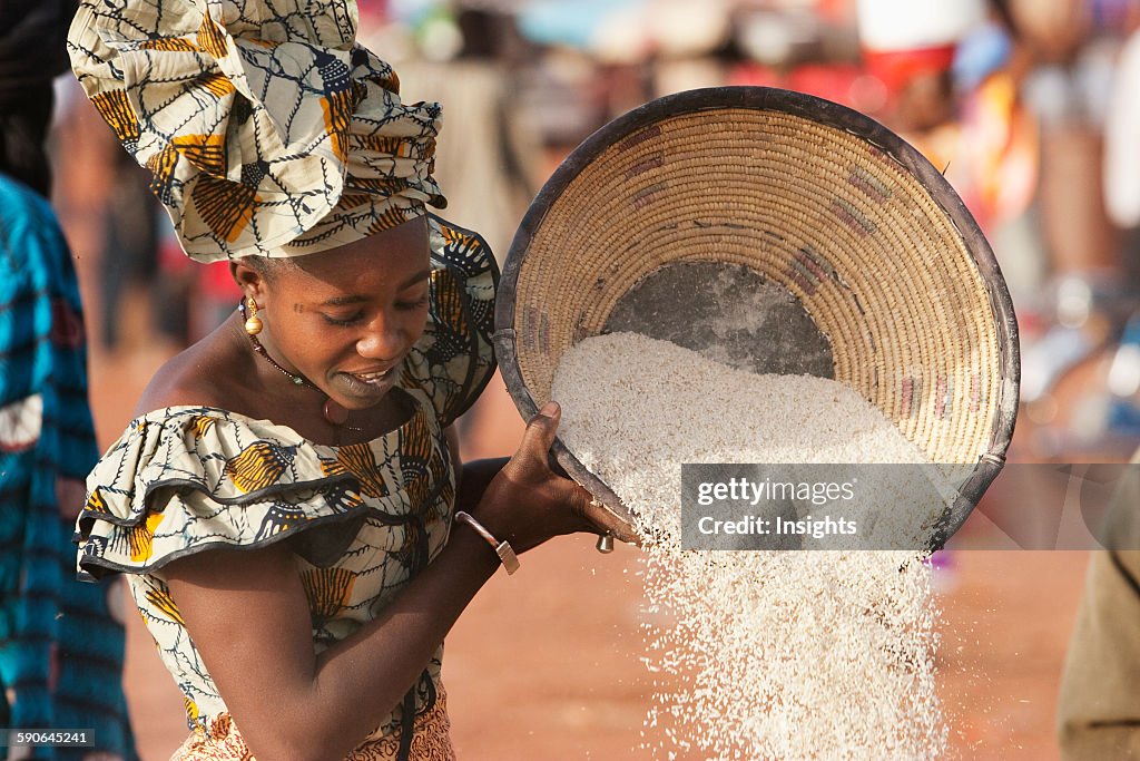 Woman sifting couscous.