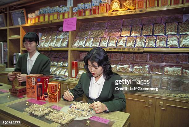 New York City, Chinatown, Mott Street, Ten Ren Tea and Ginseng Company Inc, Clerk Prepares Packages Of Ginseng.