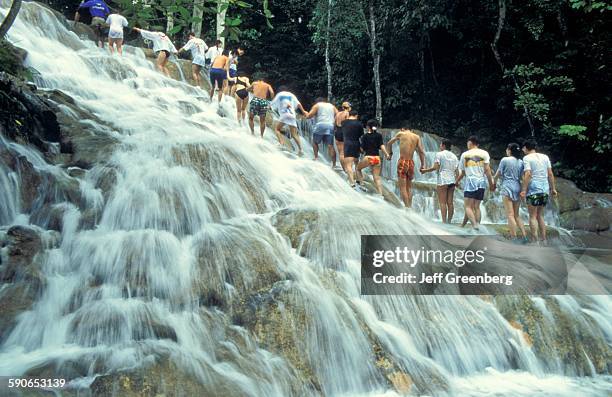 Jamaica, Ocho Rios, Tourists Form Human Chain As They Climb Dunns River Falls.