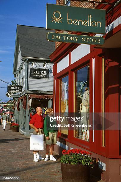 Maine, Freeport, Main Street, Shoppers Looking In Shop Window.